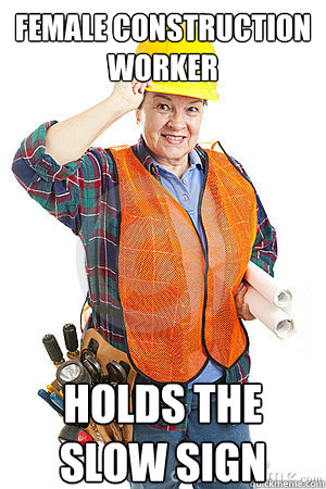 female construction worker holds the slow sign - Female Construction Worker