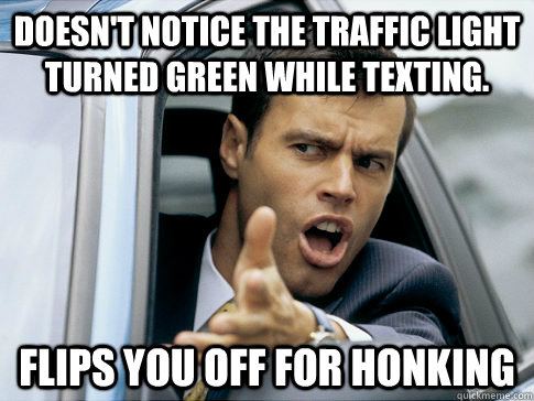 doesnt notice the traffic light turned green while texting - Asshole driver